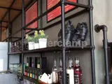 black steel tube fitted to make shelves in cafe by the menus behind the till 