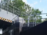 safety handrails made with steel tube from Interclamp placed on railway bridge in front of trees 