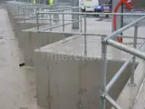 Safety handrails placed on concrete blocks at construction site 